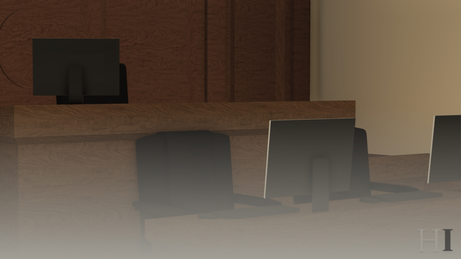The wood-paneled bench inside a Harrison County Court courtroom, with monitors set along the counsel table in the foreground.
