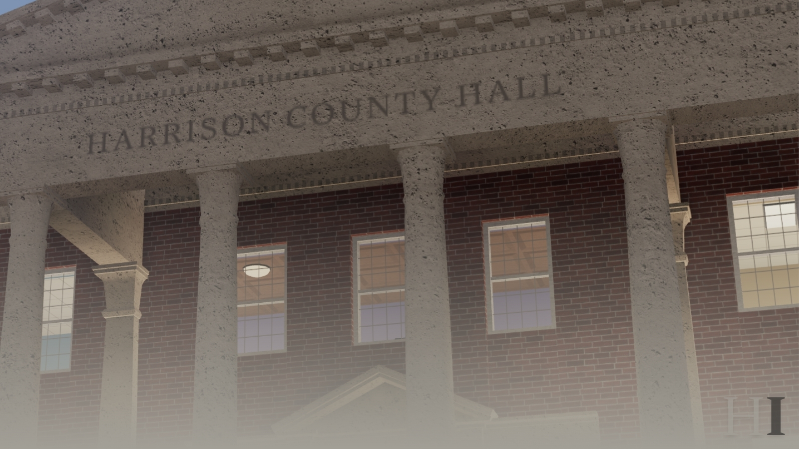 The columned facade of Harrison County Hall, seen through haze.